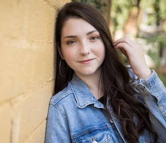 Photo of Kaitlyn Meyers, young adult, white woman with long brown hair