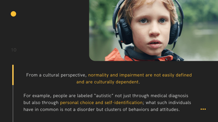 A young boy wearing an orange jacket and had black headphone on.